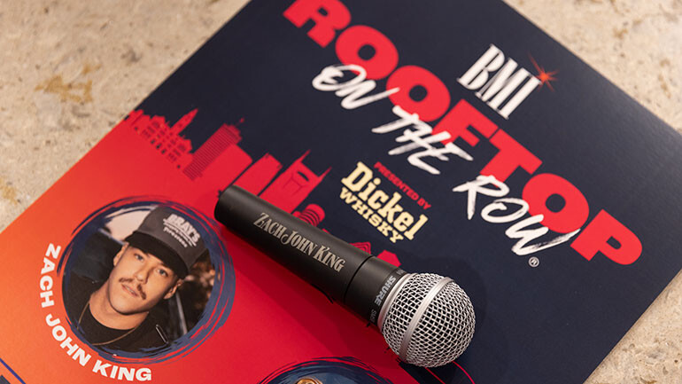 Zach John King (BMI) is gifted with a custom microphone by event sponsor Shure at BMI’s Rooftop on The Row®, presented by George Dickel Whisky.