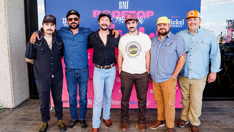 The Droptines pose with BMI’s Mason Hunter at BMI’s Rooftop On The Row: AMERCIANAFEST official kickoff party in Nashville.