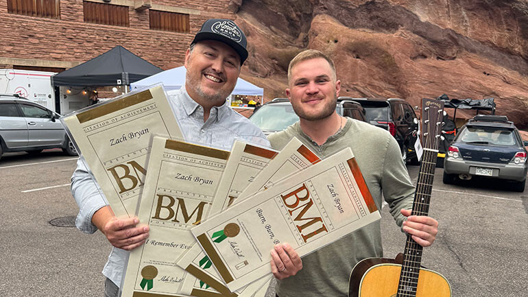 BMI’s Mason Hunter poses with Zach Bryan (BMI) after receiving awards from the 2024 BMI Country Awards.