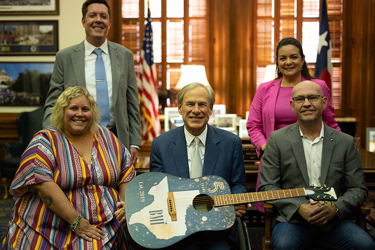 Back Row L-R: Texas Music Office’s Chip Adams, Executive Director of Economic Development and Tourism Adriana Cruz; Front Row L-R: BMI’s Kristen Townsend, Governor Greg Abbott, BMI’s Mitch Ballard.